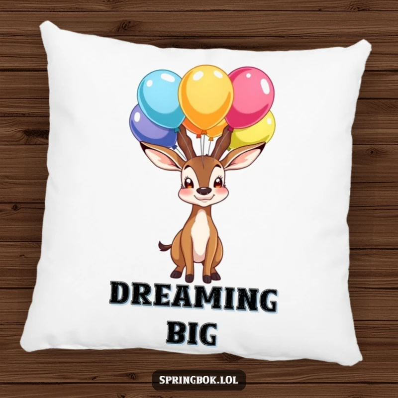 Funny pillow depicting a proud springbok character balancing colorful balloons on its nose, a soft and celebratory home accent.
