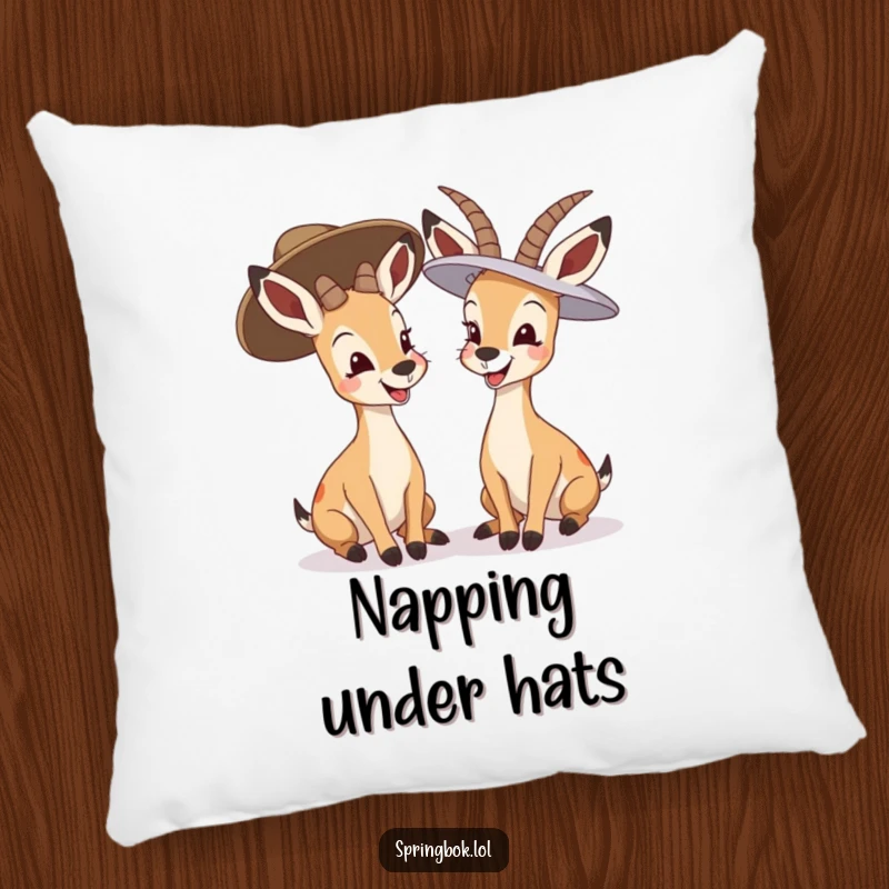 Funny springbok giggling pillow, two springboks in oversized hats laughing together, soft and humorous decor.