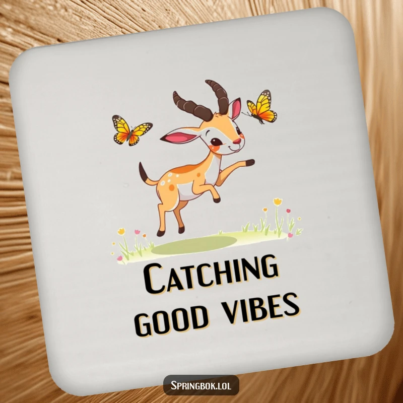 Funny springbok butterfly chase coaster, a springbok playfully chasing a butterfly, protects surfaces with humor.