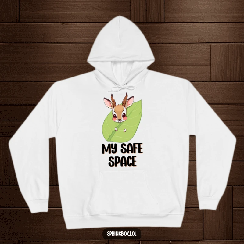 Funny Hoodie: A bashful antelope with red cheeks peeks from behind a large leaf, radiating a cute and shy vibe. Cozy and humorous.
