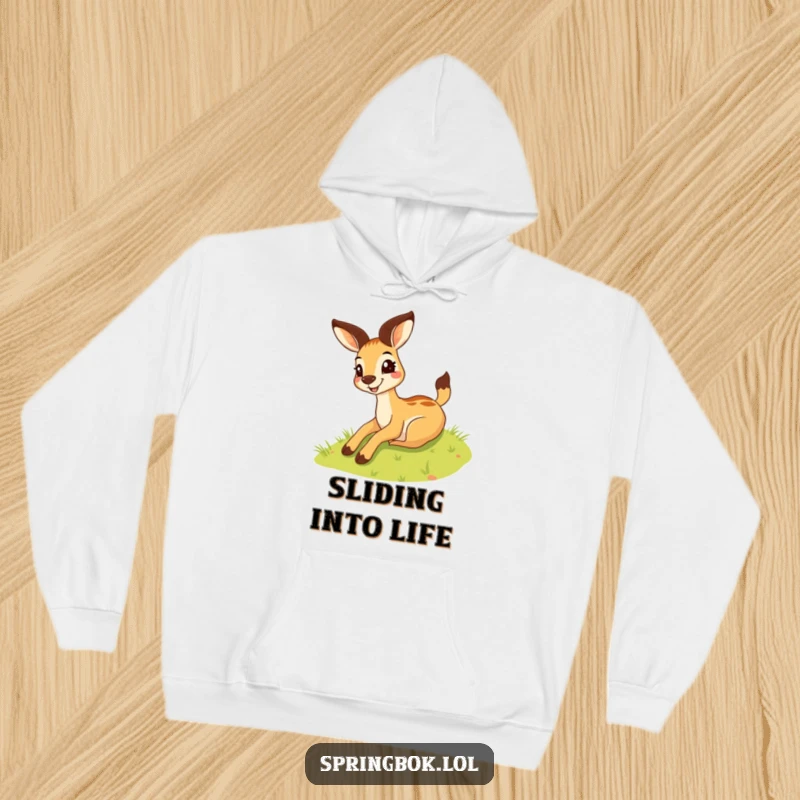 Funny springbok hoodie showing a silly springbok with a wide grin sliding down a grassy hill, perfect for cozy fun.