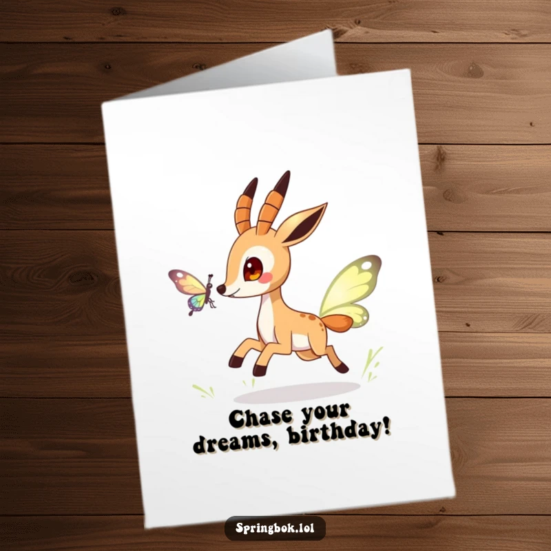 Funny free printable birthday card showing a playful springbok character excitedly chasing a shimmering butterfly through the air.