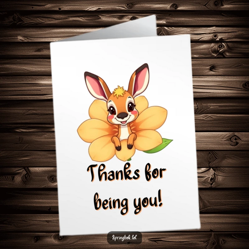 Funny Free Printable Springbok Thank You Card hiding behind a flower, offering a cute and grateful greeting.