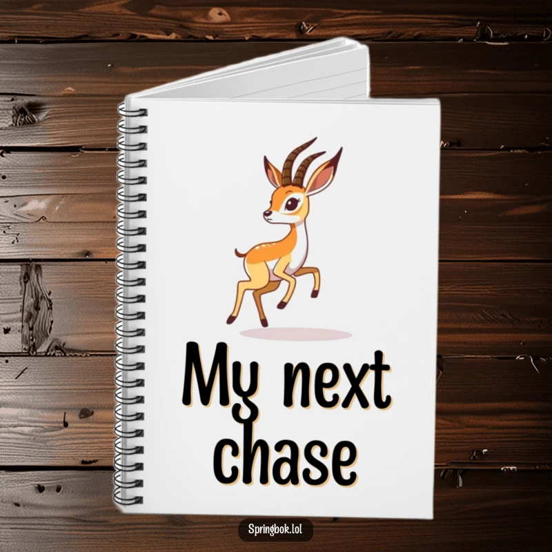 Funny springbok notebook displays a playful springbok chasing its shadow, perfect for jotting down whimsical notes.