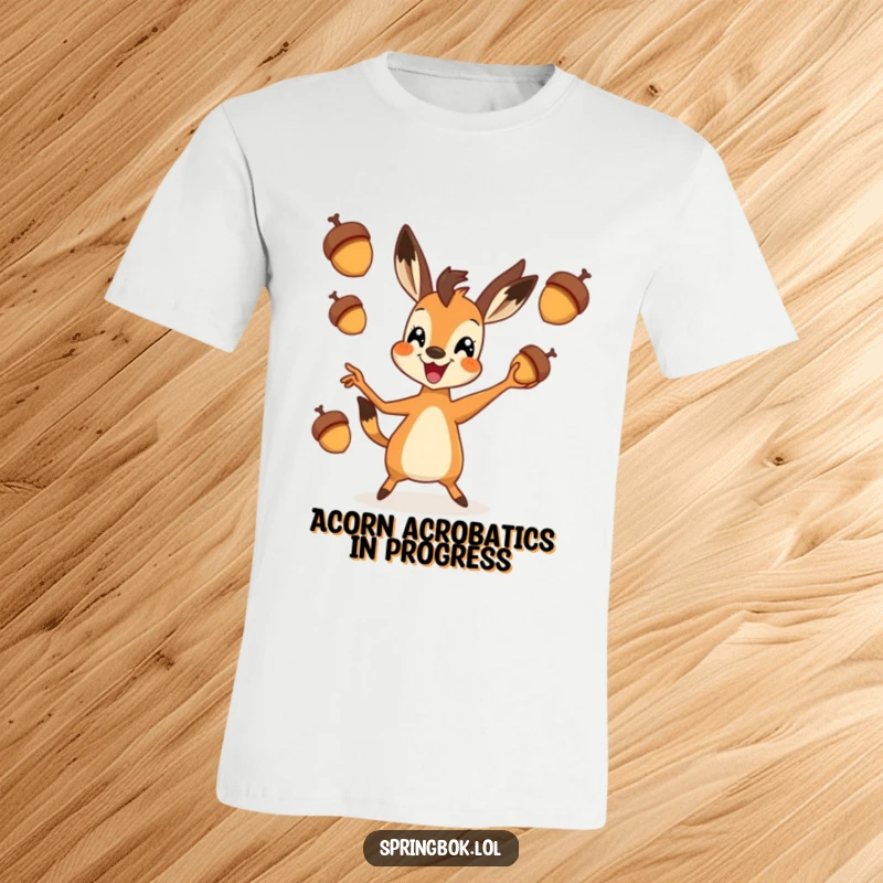 Funny springbok t-shirt featuring an energetic springbok enthusiastically juggling three small acorns, looking quite pleased with itself.