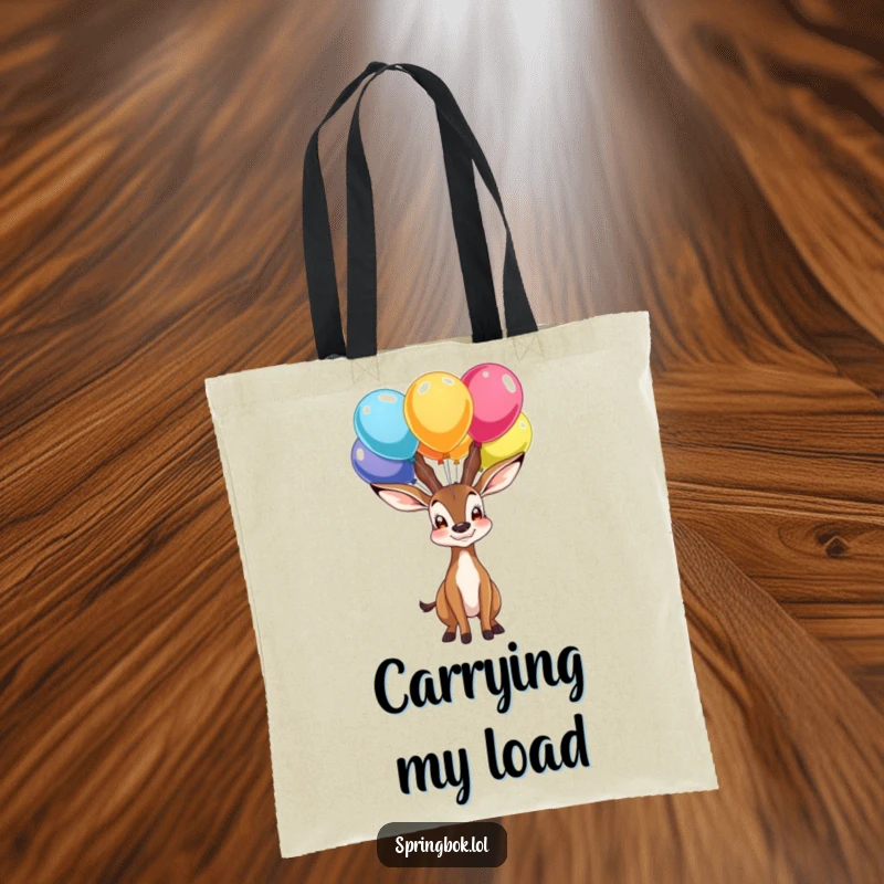 Funny tote bag showing a proud springbok character balancing colorful balloons on its nose, a whimsical and stylish accessory.