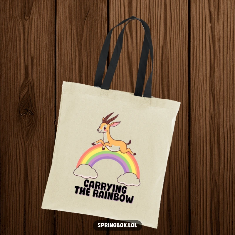 Funny tote bag showcasing a springbok jumping over a colorful rainbow, ideal for carrying everyday items with a touch of magic.